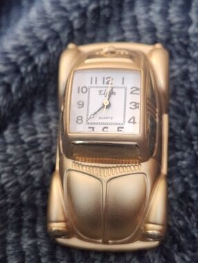 vintage Elgin Volkswagen Beetle desk clock shaped like a gold-colored classic VW